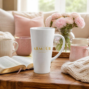 Armour latte mug with gold logo on a cosy coffee table